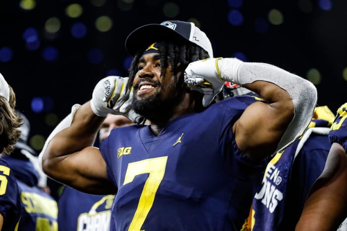 Michigan running back Donovan Edwards (7) waves at fans after the Wolverines won the Big Ten Championship after defeating Purdue 43-22 at Lucas Oil Stadium in Indianapolis, Ind., on Saturday, Dec. 3, 2022.